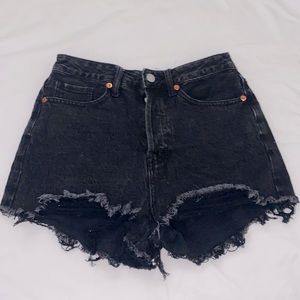 Black ripped, high waisted shorts.